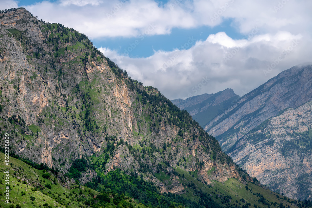 Clouds over the tops of the rocks. View of the Caucasus Mountains in Ingushetia, Russia Clouds over the tops of the rocks. View of the Caucasus Mountains in Ingushetia, Russia