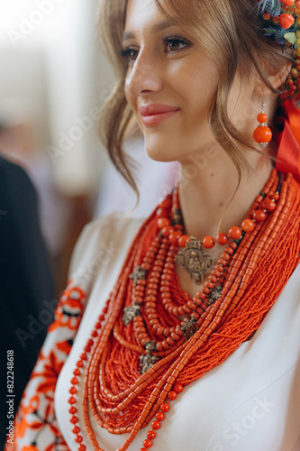 Ukrainian woman in embroidery vyshyvanka dress and ancient coral beads. Traditional necklace and costume of Ukraine. photo