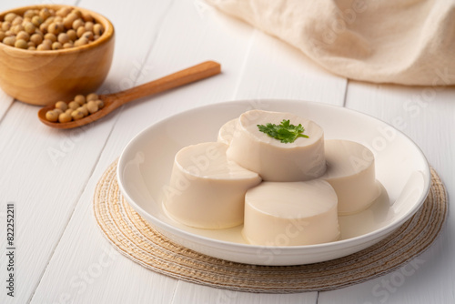 Fresh Sliced Soft Tofu soy bean curd on white plate