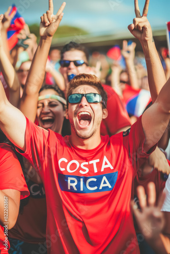 Costa Rican football soccer fans in a stadium supporting the national team, Ticos
