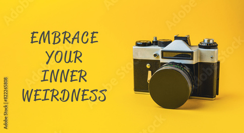 A camera with the words embrace your inner weirdness written below it photo