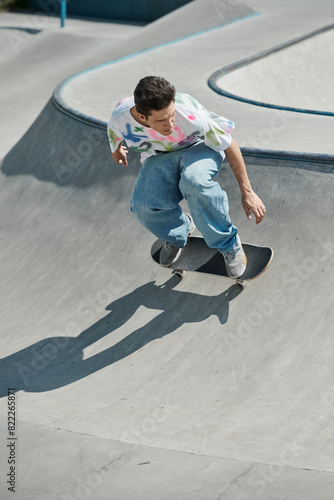 Young skater boy rides skateboard up ramp in vibrant outdoor skate park on a sunny summer day.