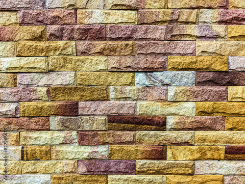 Horizontal modern brick wall for pattern and background. Stone natural abstract background pattern. Sandstone brick wall. Stone wall background in horizontal pattern for home or resident decoration.
