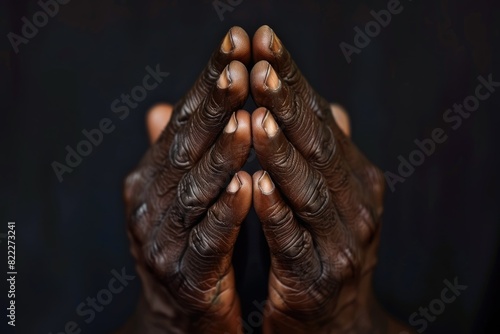African American Hands Clasped in Prayer Isolated on Dark Background - Serene and Devotional Close-Up
