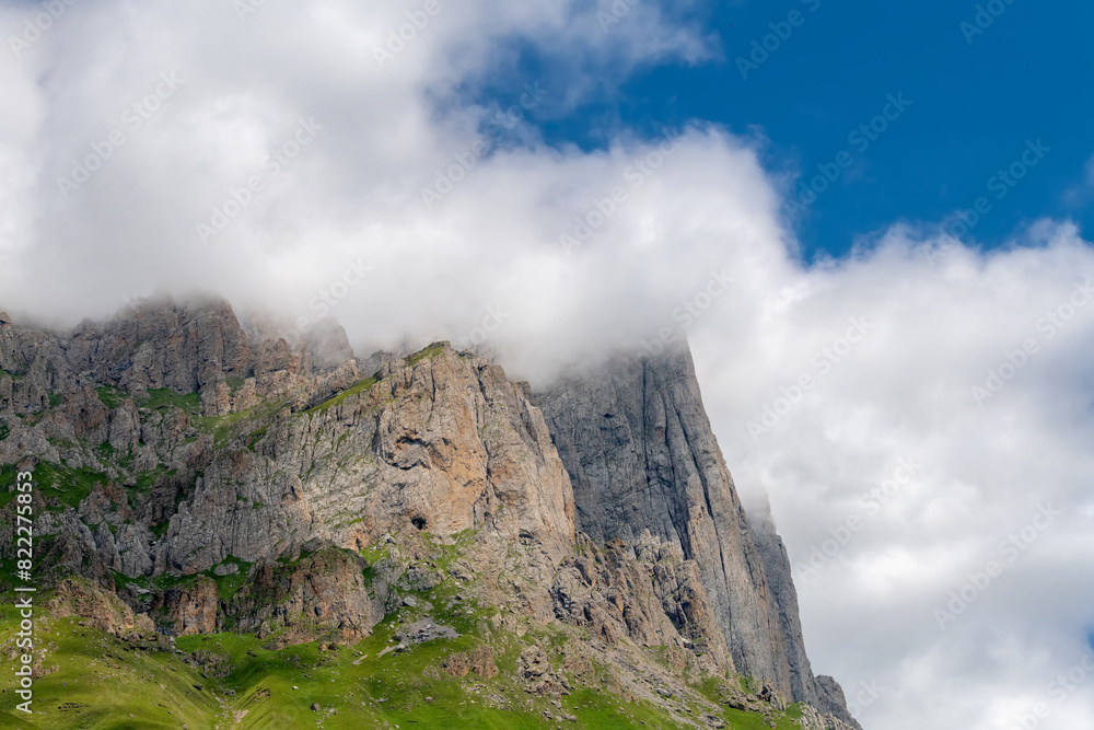 Clouds cover the peaks of the mountains. View of the Caucasus Mountains in Ingushetia, Russia Clouds cover the peaks of the mountains. View of the Caucasus Mountains in Ingushetia, Russia