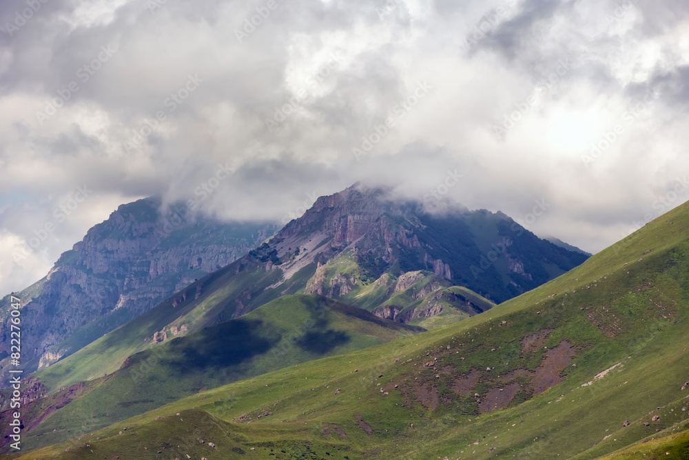 Clouds cover the peaks of the mountains. View of the Caucasus Mountains in Ingushetia, Russia