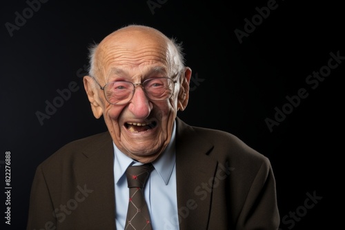 Portrait of a glad elderly man in his 90s laughing in blank studio backdrop © Markus Schröder