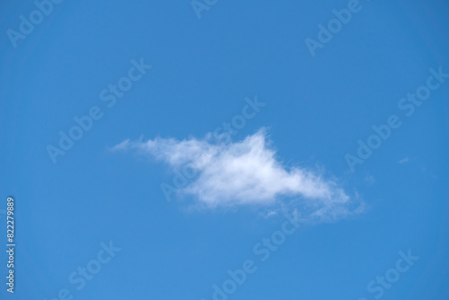 Blue sky with a single white cloud