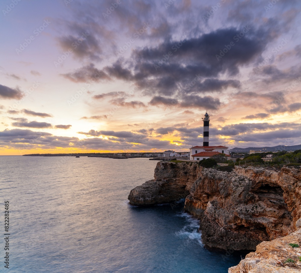 view of the Portocolom Lighthouse in eastern Mallorca at sunset view of the Portocolom Lighthouse in eastern Mallorca at sunset