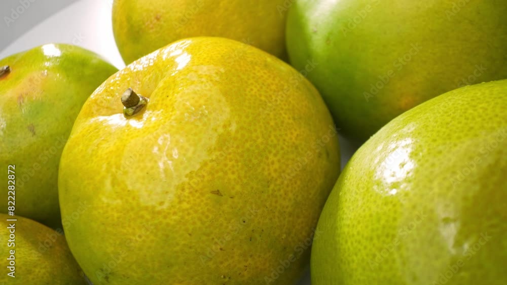 A cluster of vibrant green oranges, nestled together, their glossy skins catching the light. Shades of green meld into hints of yellow, promising succulent sweetness. Orange fruit background.
A cluster of vibrant green oranges, nestled together, their glossy skins catching the light. Shades of green meld into hints of yellow, promising succulent sweetness. Orange fruit background.