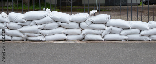 Sandbags for flood defense, river Moselle Trier in Rhineland Palatinate, flooded trees and paths, high water level, climate change