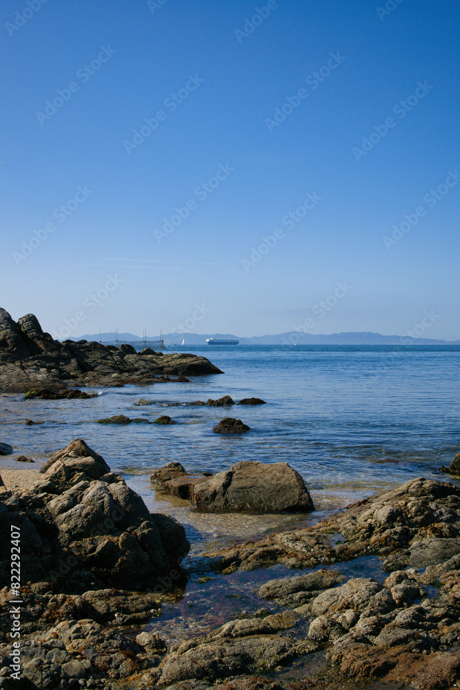 ゴツゴツした岩の潮溜りの透き通った青い海