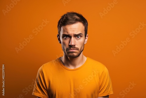 Orange background sad european white man realistic person portrait of young beautiful bad mood expression man Isolated on Background depression anxiety