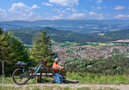 Fényképezés active senior woman on a bike packing tour with her electric mountain bikeup to