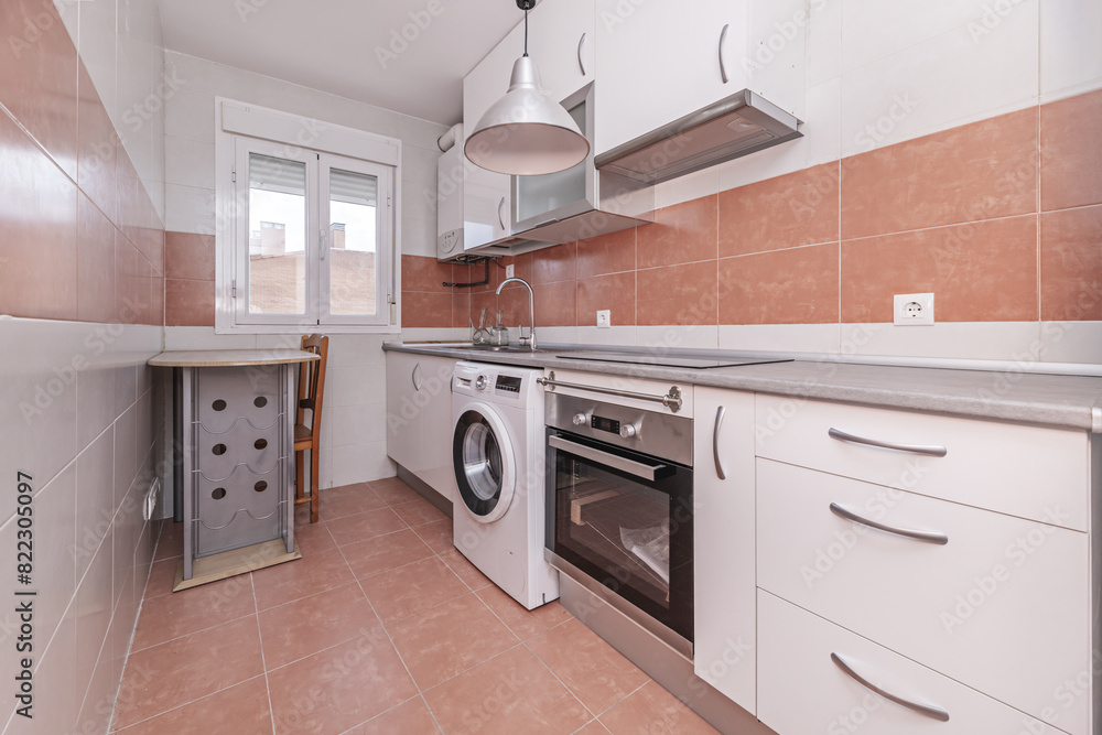 Kitchen with combined white and light brown tiles, white furniture and gray countertop Kitchen with combined white and light brown tiles, white furniture and gray countertop