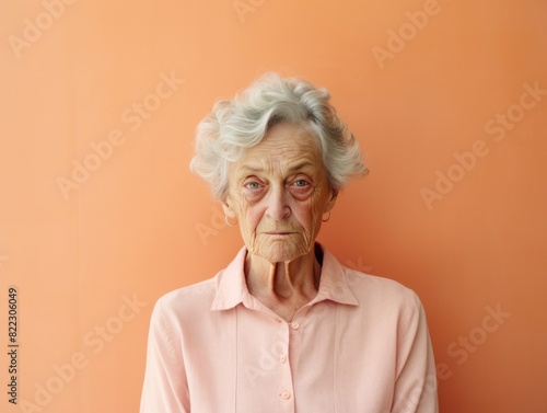 Peach background sad European white Woman grandmother realistic person portrait of young beautiful bad mood expression Woman Isolated 