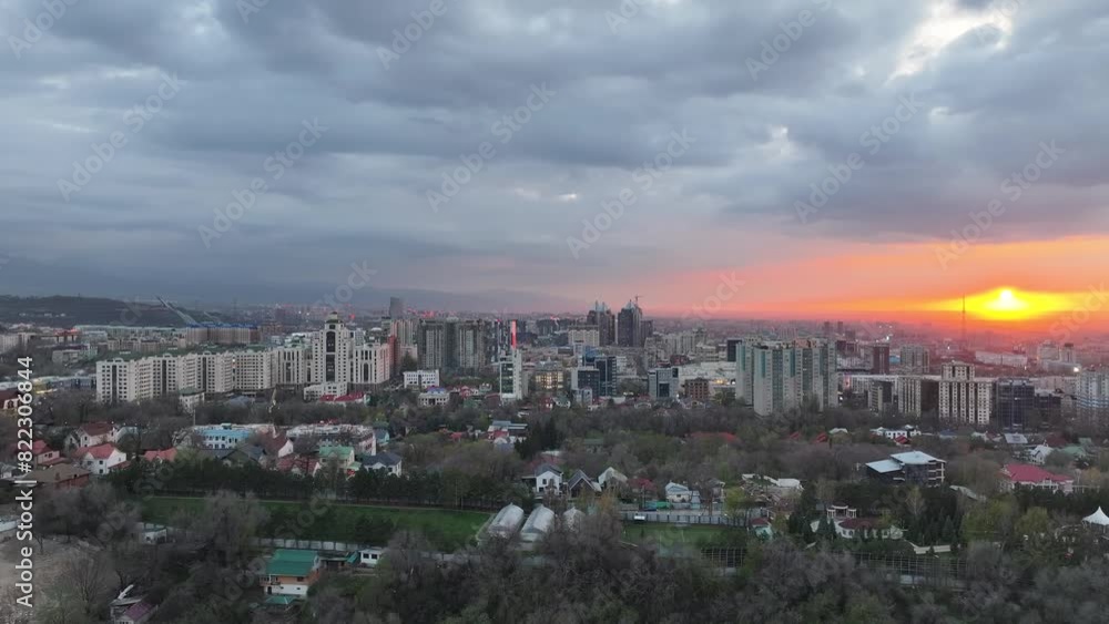 View from a quadcopter of the largest city of Kazakhstan, Almaty, on a spring evening at sunset View from a quadcopter of the largest city of Kazakhstan, Almaty, on a spring evening at sunset