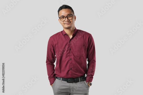 A handsome young Asian man in a suit wearing glasses and making various facial expressions isolated on a white background