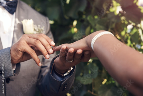 Outdoor, wedding and ring for finger, couple and vows in event, ceremony and marriage for people. Closeup, holding hands, romance and love with jewellery, groom and bride together for celebration