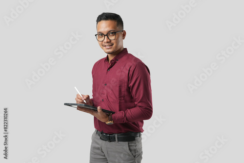 A handsome young Asian man in a suit wears glasses and makes various facial expressions while using a tablet