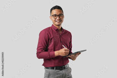 A handsome young Asian man in a suit wears glasses and makes various facial expressions while using a tablet
