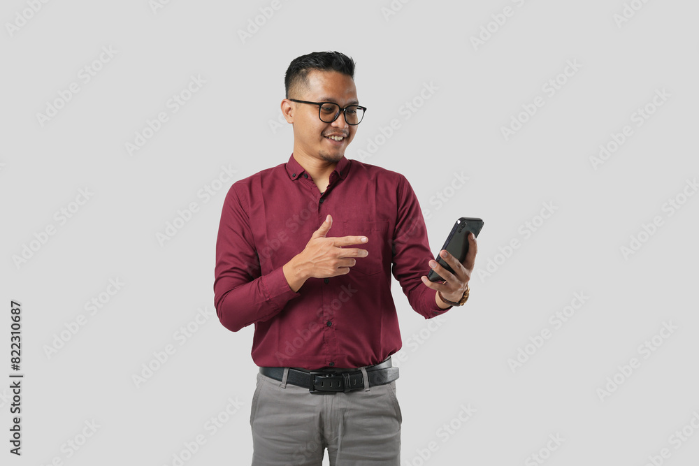 A handsome young Asian man in a suit wears glasses and makes various facial expressions while using a cellphone A handsome young Asian man in a suit wears glasses and makes various facial expressions while using a cellphone