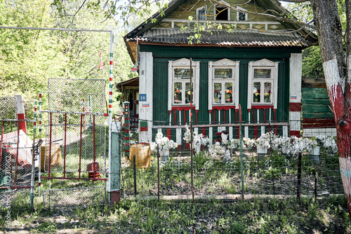 old wooden design house green with red with artificial flowers 