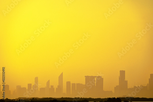 Sandstorm  samum  haboob over the southern megalopolis  the outline of skyscrapers are drowning in yellow haze. Abu Dhabi