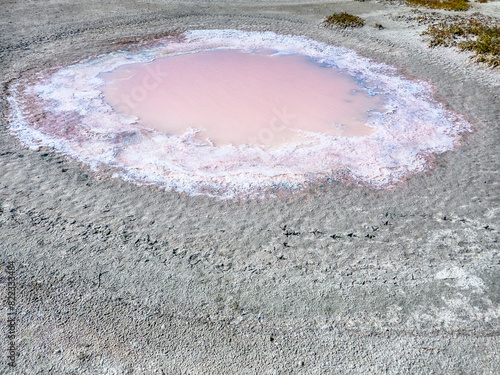 фотографія Subsidence funnels on salt marsh are filled with lakes of diverse colors