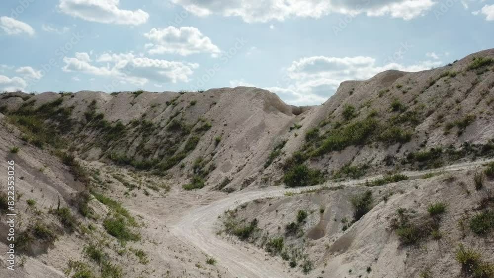Aerial view of off road track between white sands hills. Drone footage. Aerial view of off road track between white sands hills. Drone footage.