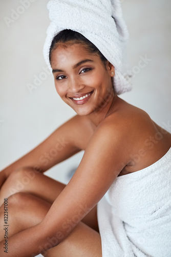 Happy, woman and portrait in skincare, towel and cosmetics for glow, healthy and wellbeing. Female person, spa and pride for natural face, self care and dermatology with beauty on background