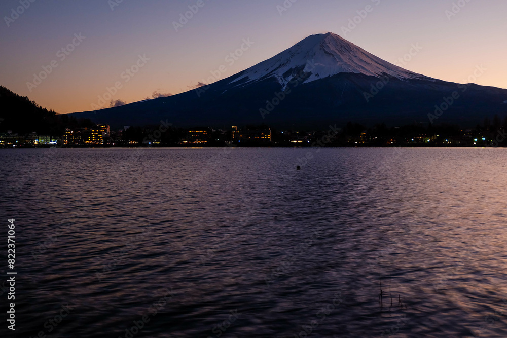 A distant view on Mt Fuji in Japan on a clear,The top parts of the volcano are covered with a layer of snow.