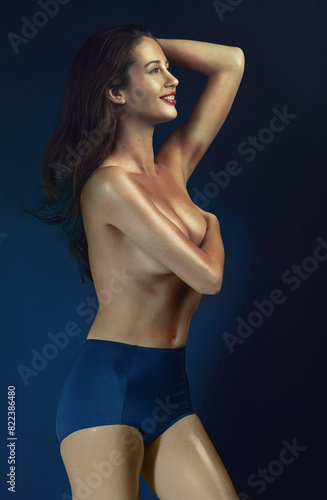Картината върху платно Woman, nude and body in studio with blue background for confidence, art deco and natural beauty