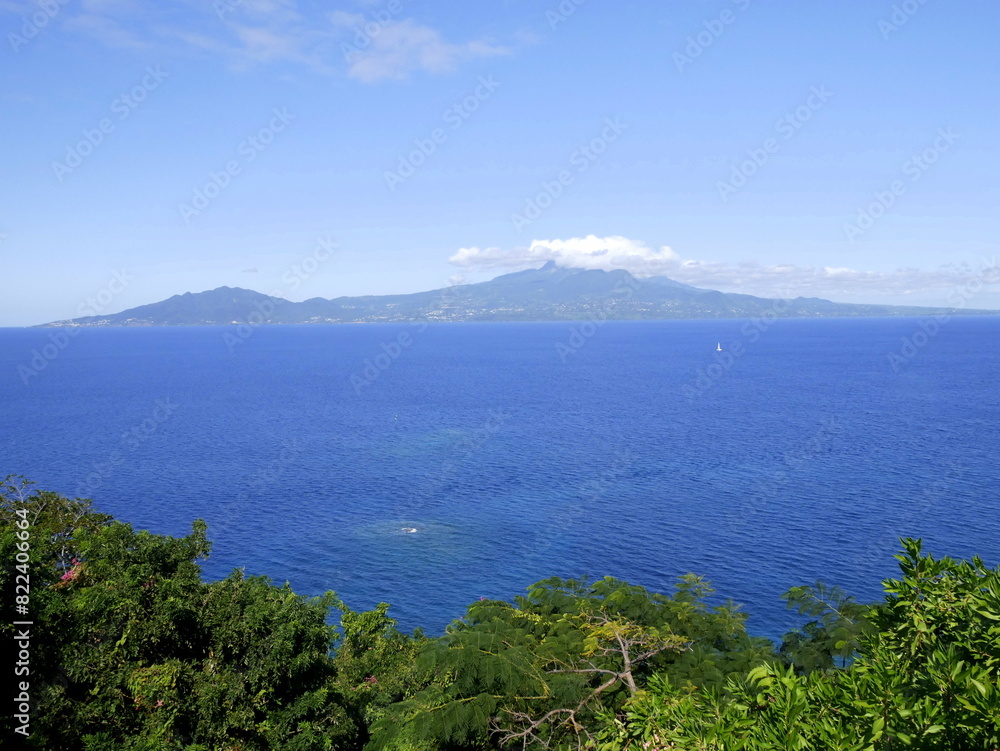 Basse Terre in guadeloupe seen from les Saintes, ocean and soufriere volcano in the cloud. Landscape horizontal photo