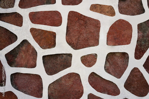 Granite wall with plaster. White cement and red natural stone texture. Rough retro surface. Vintage background for designers.