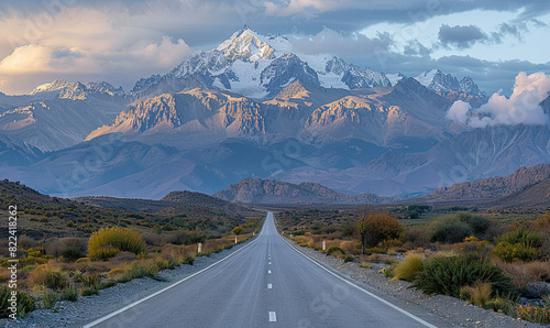 Photograph a scenic route with a straight road that stretches towards the towering Andes mountains in the background, highlighted by the soft hues of an , Generate AI © VinaAmeliaGRPHIC