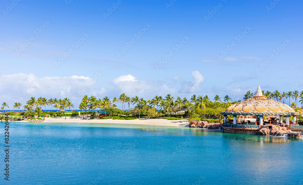 Tropical beach with palm tree, gazebo and umbrella a sunny day Tropical beach with palm tree, gazebo and umbrella a sunny day