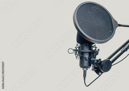 Studio microphone on stand on light background