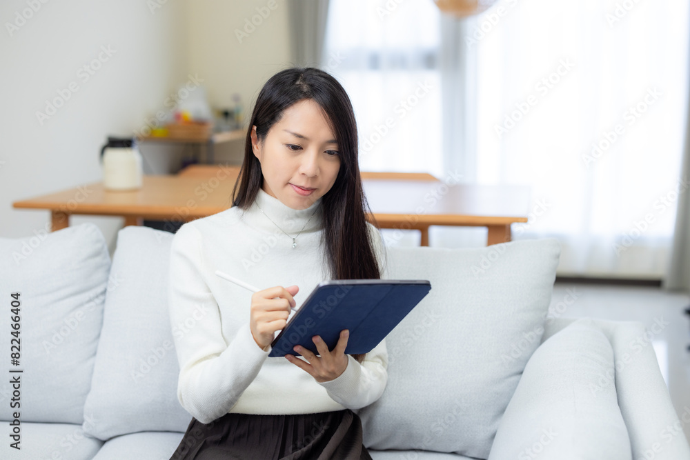 Woman use tablet with digital pencil at home Woman use tablet with digital pencil at home