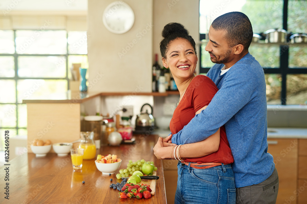Couple, hug and kitchen with fruit breakfast for gut health nutrition in home for morning, meal or orange juice. Man, woman and embrace with weight loss diet or vitamin fibre, digestion or vegetarian