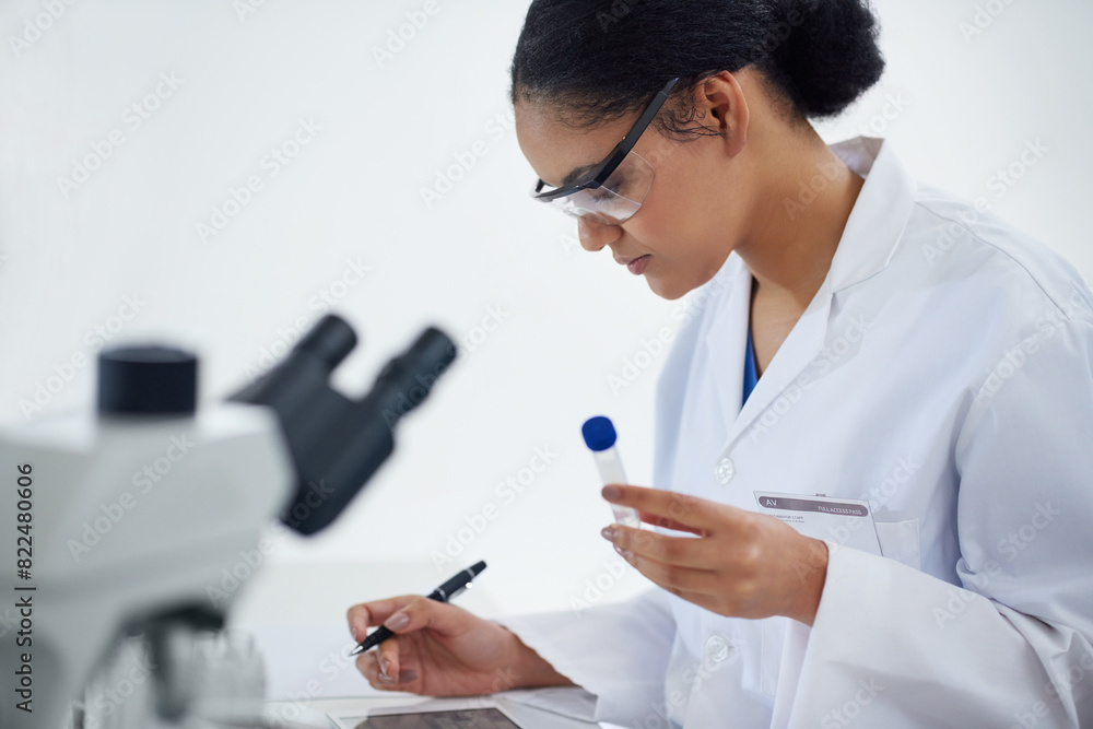 Scientist, test tube and woman with notes for research, analysis or innovation on tablet in laboratory. Science, medical professional or biotechnology to study, writing information or microscope exam Scientist, test tube and woman with notes for research, analysis or innovation on tablet in laboratory. Science, medical professional or biotechnology to study, writing information or microscope exam