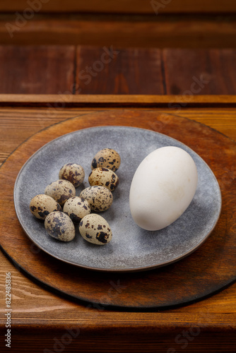 goose and quail egg on a wooden table
