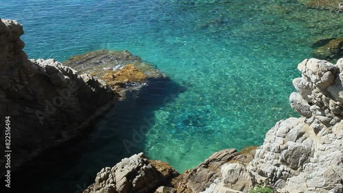 Crystal clear and clean waters of Costa Brava from the rocky promontory near Treumal beach. Lloret de Mar, Costa Brava, Girona, Catalonia, Spain. photo