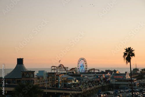 Wide angle shot of Santa Monica Pier at sunset with Pacific Ocean in the background.  photo