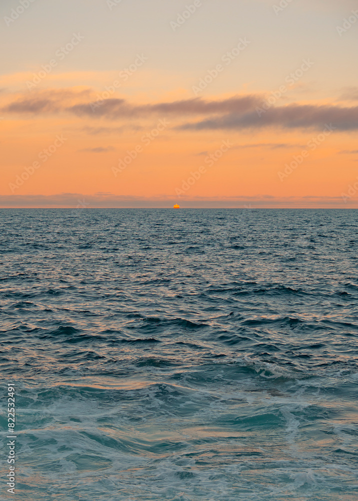 Fototapeta premium Orange Sky Sunset Over Blue Ocean