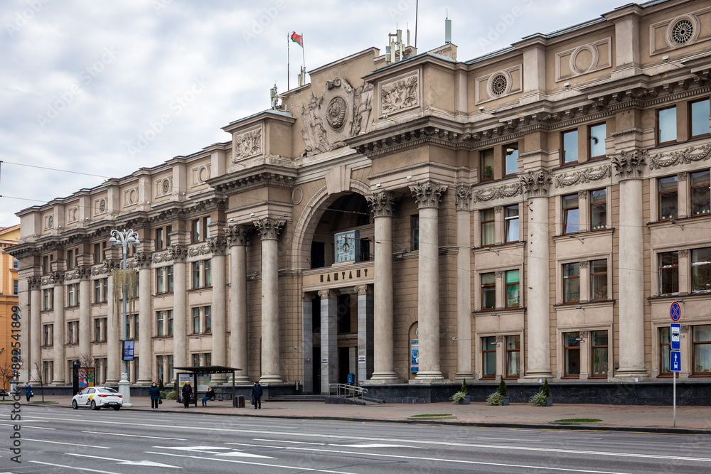 Obraz premium Central Post Office Building in Minsk, Belarus, neoclassical building with columns, sculptures and a clock.