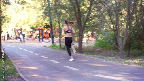 Wallpaper Mural Sporty woman jogger running on country road amidst trees during daytime. Full body of young female jogging in nature at morning.  Torontodigital.ca