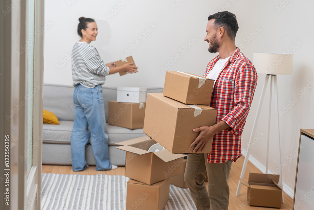 joyful couple packs boxes, symbolizing their new home purchase through a mortgage, filled with smiles and excitement joyful couple packs boxes, symbolizing their new home purchase through a mortgage, filled with smiles and excitement