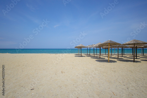 Sandy beach with straw umbrellas on the Olympic Riviera  Nei Pori  Pieria - Greece