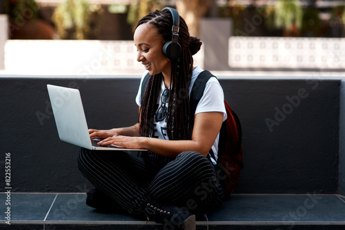 Woman, student and headset or typing laptop, outside and online classes for elearning or education. University, learner and website research for assignment, listening and podcast or school project